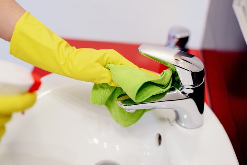 Oven cleaning with baking soda and cloth in a kitchen